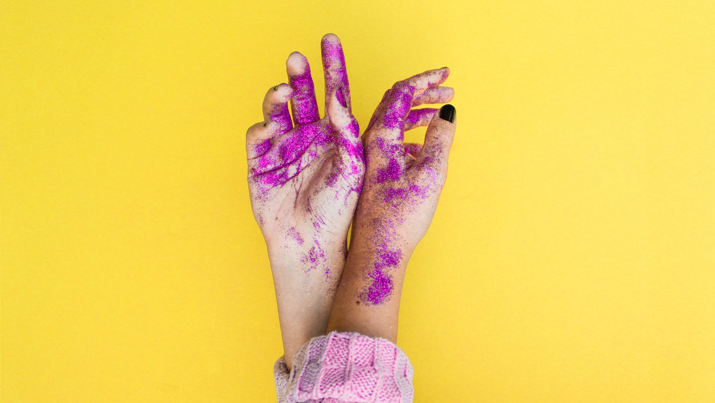 hands covered in pink glitter